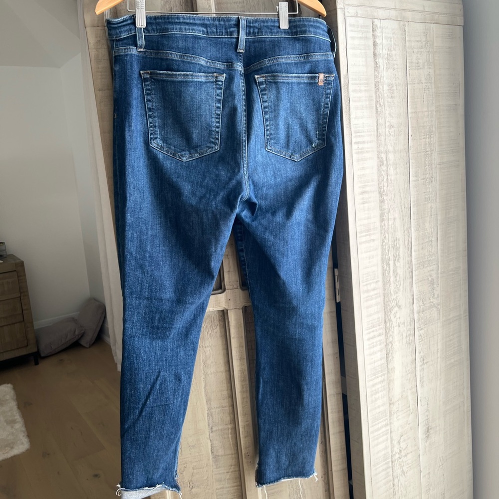Joes jeans. Very stretchy with distressed holes in  knees .